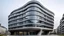 Placeholder: A building with a bold, curvilinear design nestled in a drab, grey urban environment
