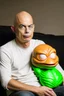 Placeholder: bald man with inflatable pepe downgrade