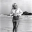 Placeholder: youthful Dolly Parton singing her famous "God/Deicide" tube on the beach