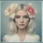 Placeholder: 1970s Polaroid head shot of a stunning young platinum straight haired woman, hair loosely pulled up and adorned with big flowers.
