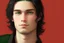 Placeholder: a young male with shoulder length black hair and green eyes, slight smile