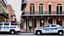 Placeholder: A police Tesla Cybertruck is chasing a Tesla 'Model S Plaid' at top speed, across the 'French Quarter' in New Orleans, Louisiana. CINEMATIC. WIDE ANGLE LENS.