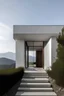 Placeholder: Acceso principal de una casa mínimalista con vista hacia unas montañas