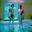 Placeholder: Justin long and his mus boyfriend are standing above thier pool showered spa heater while in tight loincloths and Nickolas is flexing there muscles while illuminated by the ambient teal glowing on the glowing marbled floor made of long flat marble slabs, the ground next to the clinical yard is in the style of primitive art. metalworking mastery, fawncore, the immaculately composed quality of this photo shows the artist was taken with provia, detailed wildlife, isaac grünewald, rustic simplicity