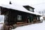 Placeholder: Snowy cabin in the mountains with a scary atmosphere and deers going around the cabin and in the snowstorm