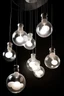 Placeholder: set of ceiling industrial lamps shaped as bath bubbles, some bubbles are couples with other small ones and some are singles pieces, the cable that takes them to the ceiling has knots