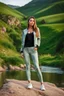 Placeholder: fullbody shot of young-beautiful-girl-with-a-perfect-face-with-make-up-wearing- sport pants and jacket standing ,geen hills ,nice nature environment ,wild flowers,clean water river with colorfull rocks in floor