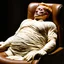 Placeholder: a chubby extremely mummified male corpse, eyes closed, strawberry blonde hair, leaned over in a brown chair