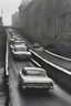 Placeholder: Old cars driving down a bridge with a city behind them, in the style of eero saarinen, the helsinki school, eve arnold, wimmelbilder, industrial urban scenes, modernist street scenes, dmitry vishnevsky Black and white photo of cars traveling down a road, in the style of soviet avant-garde, industrial urban scenes, fujifilm eterna 400t type 8673, the helsinki school, light amber and sky-blue, die brücke, midcentury modern --ar