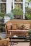 Placeholder: Night, twilight, a light brown wicker sofa with floral cushions, a glass-topped table in front of it, coffee steaming in a porcelain cup, and a down-turned open book next to it. Above the settee, flower bushes in planters, all on the terrace of a luxury house S<AI Nikon D850 highly detailed digital painting sharp focus elegant intricate photorealistic 4k very attractive beautiful dynamic lighting award winning fantastic view crisp quality Unreal Engine very cute cinematic postprocessing acrylic