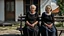 Placeholder: gloomy-looking old women sitting in black hungarian villager dress and wearing east european black head scharf on wooden bench in front of white old house outside in an authentic east european ,hungarian village, high detalied, professional photo, high qualit, high textures. The high-resolution image captures the essence of authenticity and realism, transporting the viewer to another time and place.