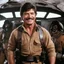 Placeholder: [in the spaceship] Charles Bronson smiles, ready to fight, in dust, rust and blood, his body is covered with cartridge belts