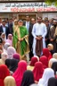 Placeholder: Opening shot: A noisy public place with a small and tense crowd gathered around Dr. Shumukh, a 10-year-old girl, a fierce and confident business leader Arabian style