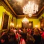 Placeholder: Party in a schloss, cheering people, Austrian aesthetic, warm colors, wooden floor, green walls, red, 8k, HD, cinematography, photorealistic, Cinematic, Color Grading, Ultra-Wide Angle, Depth of Field, hyper-detailed, beautifully color-coded, insane details, intricate details, beautifully color graded, Cinematic, Color Grading, Editorial Photography, Depth of Field, DOF, Tilt Blur, White Balance, 32k, Super-Resolution, Megapixel, ProPhoto RGB, VR, Halfrear Lighting, Backlight