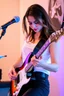 Placeholder: attractive woman playing an electric guitar
