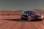 Placeholder: A Tesla 'Model Y' is parked, in the Mojave Desert. (CINEMATIC, WIDE ANGLE LENS, PHOTO REAL)