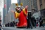 Placeholder: macys thanksgiving day parade style cartoonish jesus parade balloon pulled by multiple grim reapers, multi colored, bright, vivid, psychedelic, high detailed, high gloss, insanely detailed, matte, horrorcore, lining the street, unsettling contrast, monument to death, live action shot grim reaper parade, pulling a jesus parade float