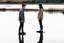 Placeholder: An image of two people exchanging criticism in a constructive and respectful manner, standing on the ground with a lake behind them