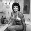 Placeholder: [photo by Russ Meyer] happy Oro wrestler Sherry Martel covered by tattoos for the Sordid Seventies in her bathroom