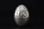 Placeholder: a silver egg in the style of Alma Pihl – that says 100 on it
