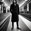 Placeholder: A young Asian man with long hair and a black trench coat waiting for a woman at a train station in Tokyo