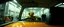 Placeholder: car driving happy insect man in the style of Escher and Giger and Fallout 4, pinhole cam, airbrush 3d rendering, on tv screen:A five-second cinematic single take in a clean industrial presentation hall.