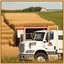 Placeholder: Side Door of a white truck with a logo for a wheat farm that features a tractor and wheat with text: "Pozniak Farms"