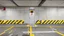 Placeholder: wall design for parking garage, concrete, yellow painted hazard lines, weathering and water stains, in middle is an exit doorway with small window, with a sign is above. rough painted hashmarks and parking lines, add signage found in a parking garage.