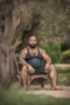 Placeholder: half figure shot photography of a marocan ugly dirty burly muscular chubby farmer 36 years old, bullneck, strong arms, big belly, manly chest, very sweat, shirtless, short beard, tattoo, curly hair , short bulging pants, open legs sitting on a chair under an olive tree , big tights, barefoot, ambient occlusion, hyper detailed photography, photorealistic, 35mm lens, side light, frontal view from below, natural colors