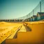 Placeholder: Photograph, wasteland, noon-light, huge fence in the background, bright, brutalist steps, yellow, daylight, details of the powder very accentuated, high contrasts, fence, powder, aluminum, row of houses, close-up of an surface, glossy, organic, strong texture, fiotti.