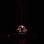 Placeholder: Solid black background. A cracked puppet mask lies on the floor, thin glowing red strings attached to it, leading upward into darkness. Subtle smoke and reflections, moody cinematic realism, symbol of hidden control and loss of self.