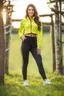 Placeholder: fullbody shot of young-beautiful-girl-with-a-perfect-face wearing sport pants and sport blouse and sport jacket and shoes standing in country side green field day lights