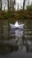 Placeholder: The image shows a white paper boat floating on top of a body of water. The boat appears to be made of paper and is in the shape of a sailboat. The water is still and there are small ripples around the boat. The background is blurred, but it seems to be a wooded area with trees and bushes. The image is taken from a low angle, looking up at the boat and the water.