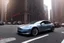 Placeholder: A Tesla 'Model S' is parked, on 'Wall Street', in New York. (CINEMATIC, WIDE ANGLE LENS, PHOTO REAL)