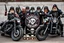 Placeholder: a very hard and tuff motorcycle bald gang, posing with their Harley Davidsson bikes, some of them holding guns and shotguns, a logo sign with Falköpings HD Club, "Fearless sinners" Skulls and bones, skeletons