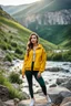 Placeholder: fullbody shot of young-beautiful-girl-with-a-perfect-face-with-make-up-wearing- sport pants and jacket standing ,geen hills ,nice nature environment ,wild flowers,clean water river with colorfull rocks in floor