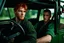 Placeholder: Photograph of a young rugged looking male with red hair and green eyes sitting in the drivers seat of a jeep close up photo realistic