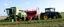 Placeholder: Parked at the edge of a field is a Claas brand Combine(left) Vaderstad implement Seeder(middle, red) and a John Deere Tractor(right) simplified