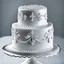 Placeholder: A picture of a simple white cake with silver decoration