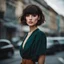 Placeholder: beautiful young woman with dark short hair, with a stylish babette hairstyle, with bangs over her eyes, against the background of the street, strong wind, stylish photo, fashion photo