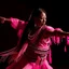 Placeholder: A female dancer in pink light designed in Navajo yarn