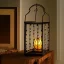 Placeholder: fireflies inside a wrought iron lantern