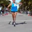 Placeholder:  old Sonia Lombardi running a marathon on Miami beach, full body, about to cross the finish line, photo realistic, 8k, realism