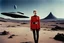 Placeholder: [color photo by Helmut Newton] female starfleet cadet torned jacket uniform horrified by a monster in a desolate landscape beside a starship.