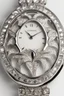 Placeholder: White gold engraved wristwatch containing white crystal jewels in the shape of a lily White background