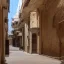 Placeholder: in an dark dirty underground city with many buildings pueblo, greek, and islamic architecture