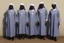 Placeholder: 4 suore africane con tunica grigia figura intera sorrisi, visi armoniosi