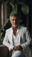 Placeholder: Portrait of a handsome older italian gentleman wearing crisp white linen suit, and an open necked shirt. His dark hair is peppered with grey, his neatly trimmed beard is dark and peppered with grey