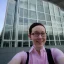 Placeholder: A short haired, female software engineer taking a selfie in front of Building 92 at Microsoft in Redmond, Washington