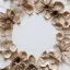 Placeholder: circle arrangement of small pressed flowers on white textured paper, dried flowers, aesthetic layout, beautiful composition, vintage, brightly lit, tender